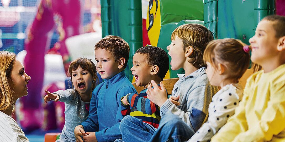 Children singing with their teacher.