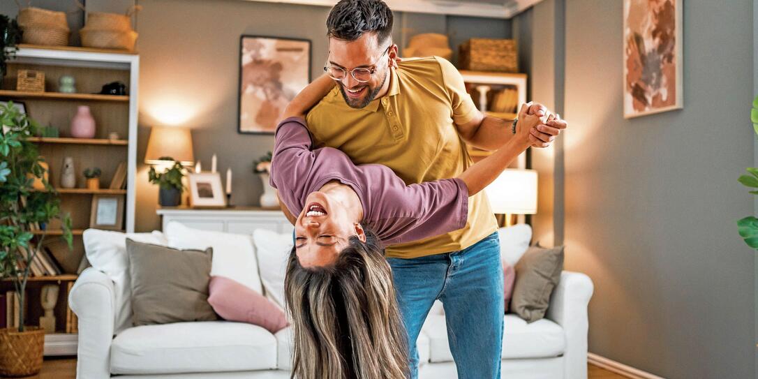 Happy couple dancing together at home Happy couple dancing together at home