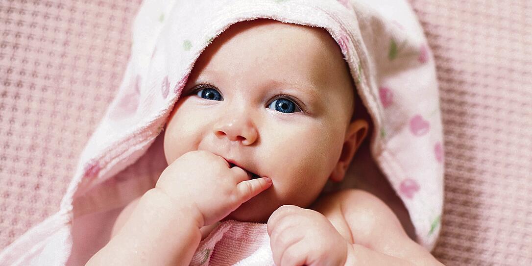 Authentic portrait of 4 months baby girl wrapped in towel after bath. Authentic portrait of 4 months baby girl wrapped in towel after bath.