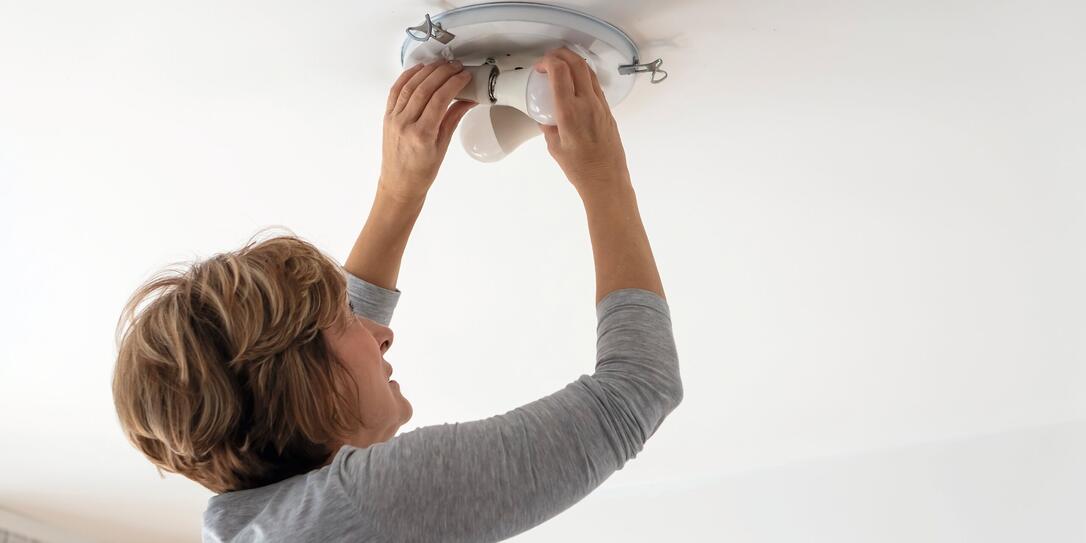 Woman Bulb replacement at home Woman Bulb replacement at home