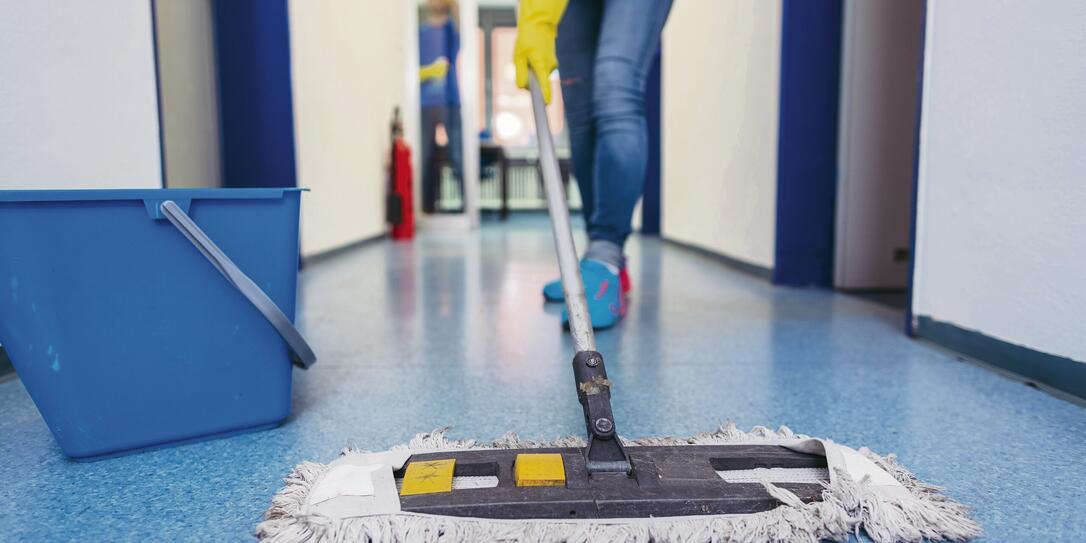 Close-up of cleaners moping the floor