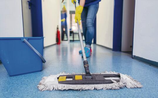 Close-up of cleaners moping the floor