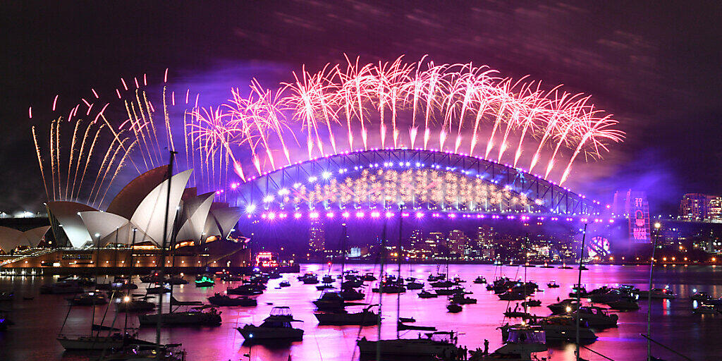 The midnight fireworks light up Sydney Harbour and the Sydney Harbour Bridge during New Year’s Eve celebrations in Sydney, Friday, December 11, 2020. Sydneysiders were asked to stay home and watch the fireworks on television this year to due the COVID-19 pandemic. (AAP Image/Mick Tsikas) NO ARCHIVING