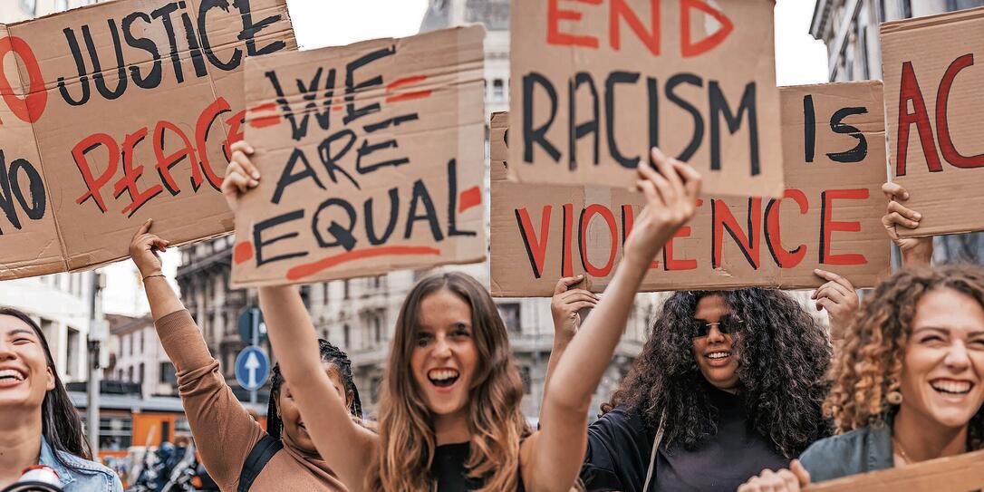 Anti-racism protest in the city street. A group of students marching together