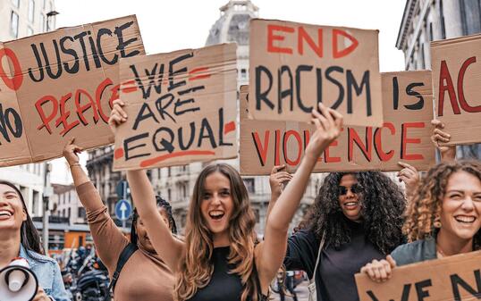 Anti-racism protest in the city street. A group of students marching together