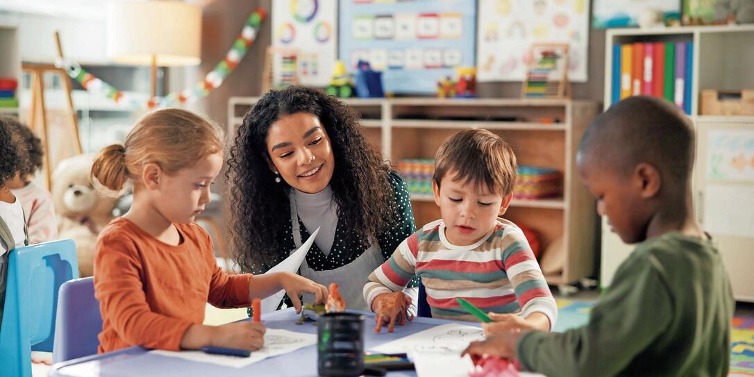 Drawing, education and teacher with children in classroom for learning, students and creative art. Growth, kindergarten and academy with woman and kids at school for helping and child development