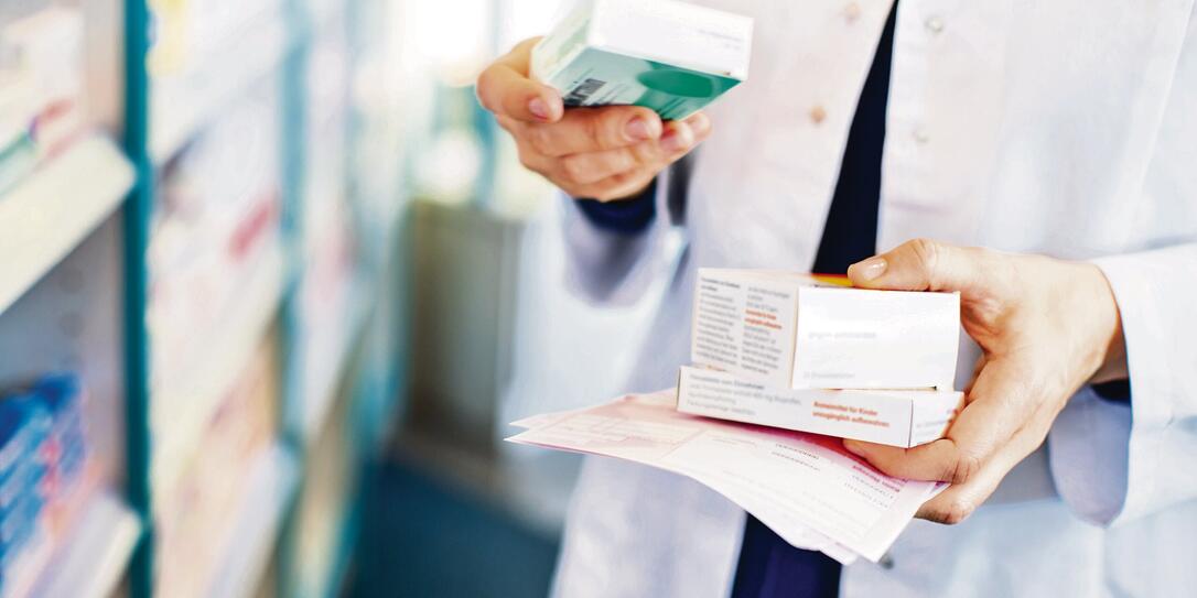 Pharmacist's hands taking medicines from shelf Pharmacist's hands taking medicines from shelf