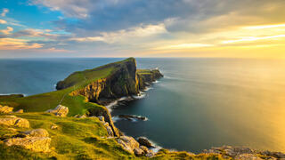 Beautiful golden light at sunset at Neist Point Lighthouse on the Isle of Skye, Scotland.