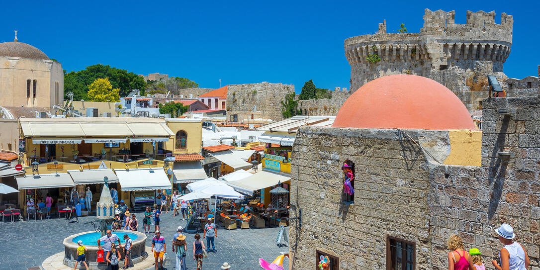 Tourists at the intersection Aristotle Str""Socrates Str- Hippocrates square at the Rhodes old town of Rhodes, Greece