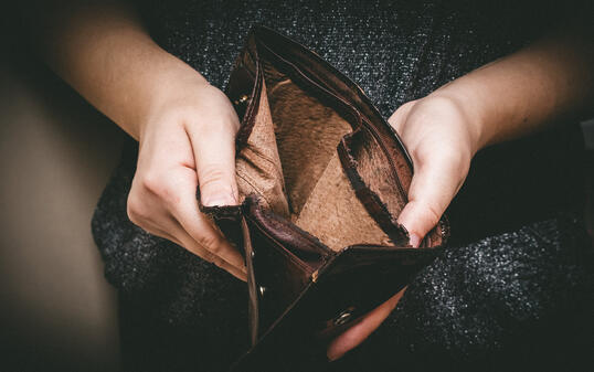 Old empty wallet in the hands .Vintage empty purse in hands of women . Poverty concept, Retirement. Special toning