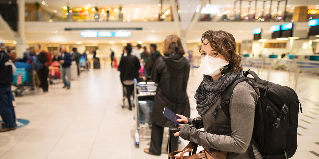 At the airport with a face mask