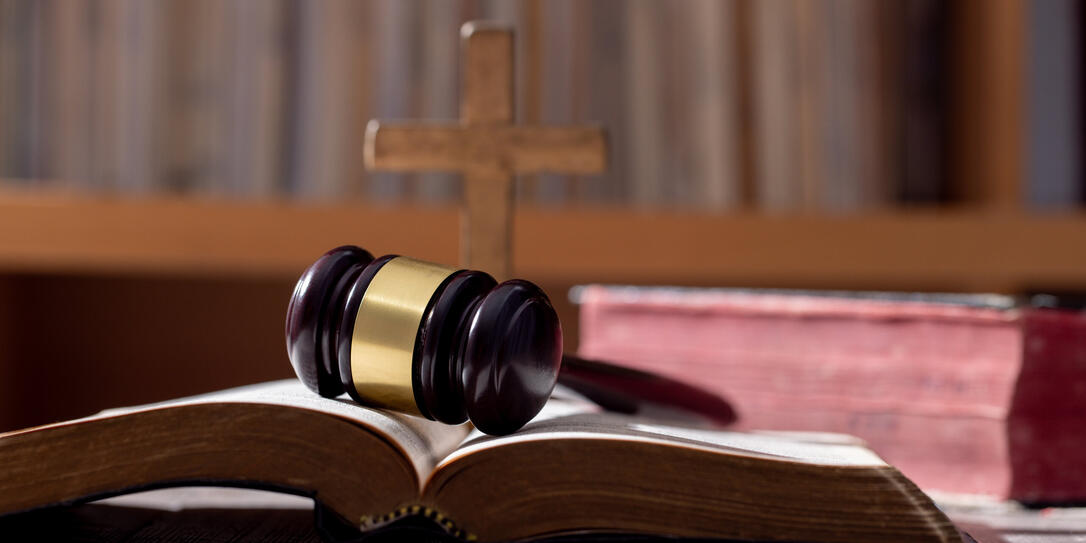 Holy bible book and judge's gavel on table background. Judicial system, constitution, democracy, rule of law. There are no people in the photo. There is free space to insert.