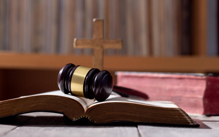 Holy bible book and judge's gavel on table background. Judicial system, constitution, democracy, rule of law. There are no people in the photo. There is free space to insert.