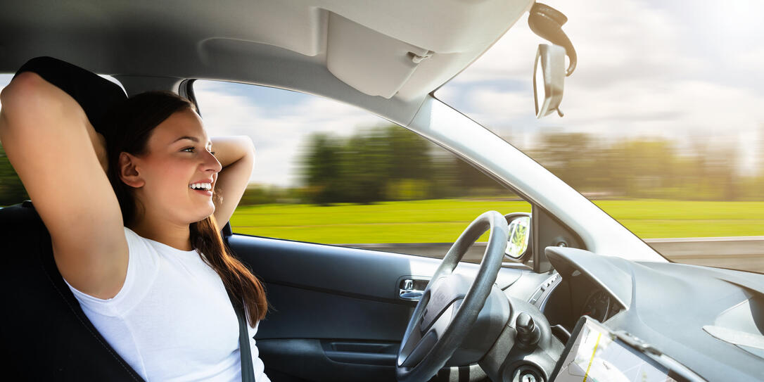 Woman Sitting In Self Driving Modern Car