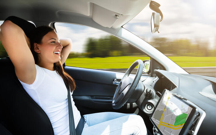 Woman Sitting In Self Driving Modern Car