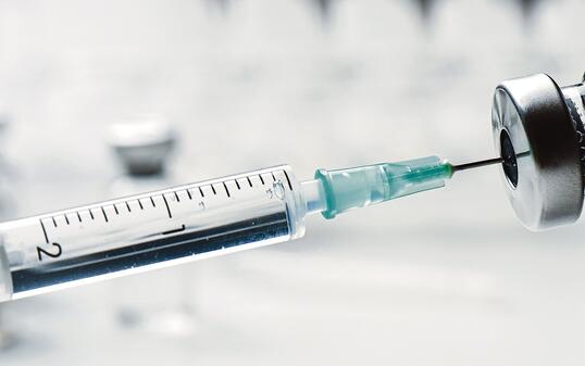 Vaccine bottle and syringe closeup