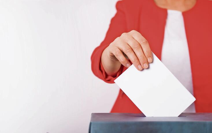 Voter Putting Ballot Into Voting box.