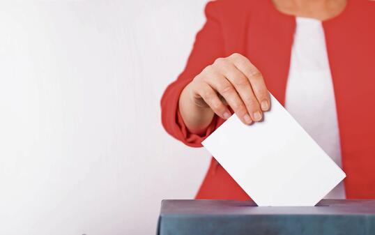 Voter Putting Ballot Into Voting box.