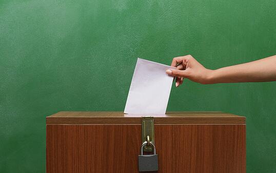 Poll Envelope In Human Hand Inserting To The Ballot Box