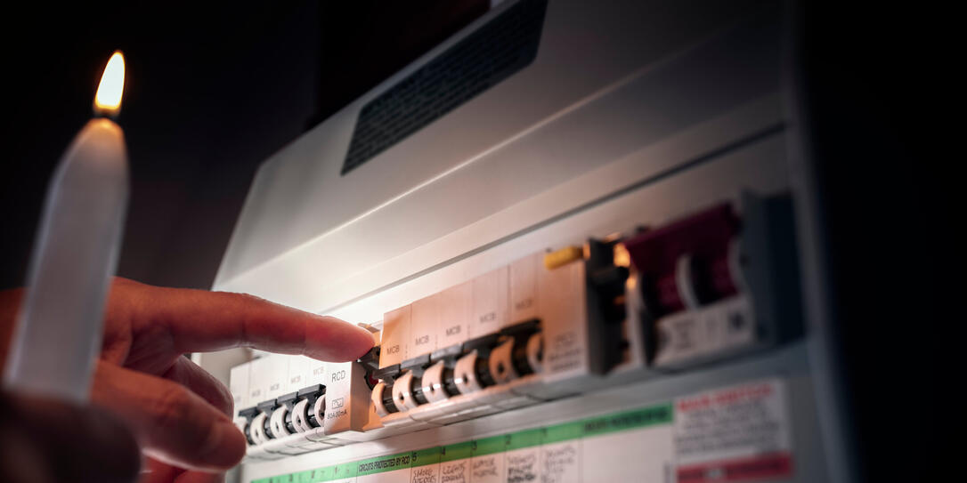 Electricity power outage or blackout emergency turning on or off circuit breaker on electrical fuse board