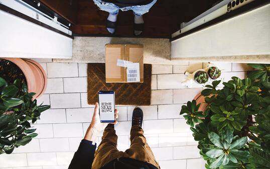 Package delivery during Covid-19 outbreak. The man is keeping social distancing