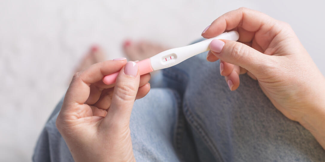 Woman holding in hands pregnancy test.