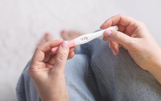 Woman holding in hands pregnancy test.