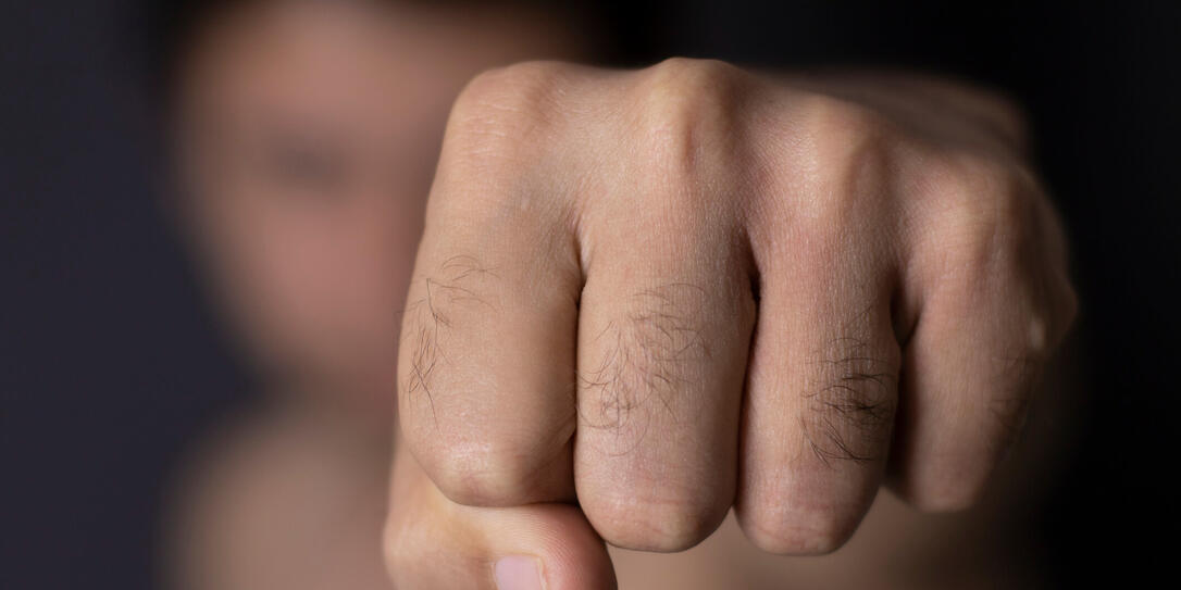 Violent man throwing punch with blurred face