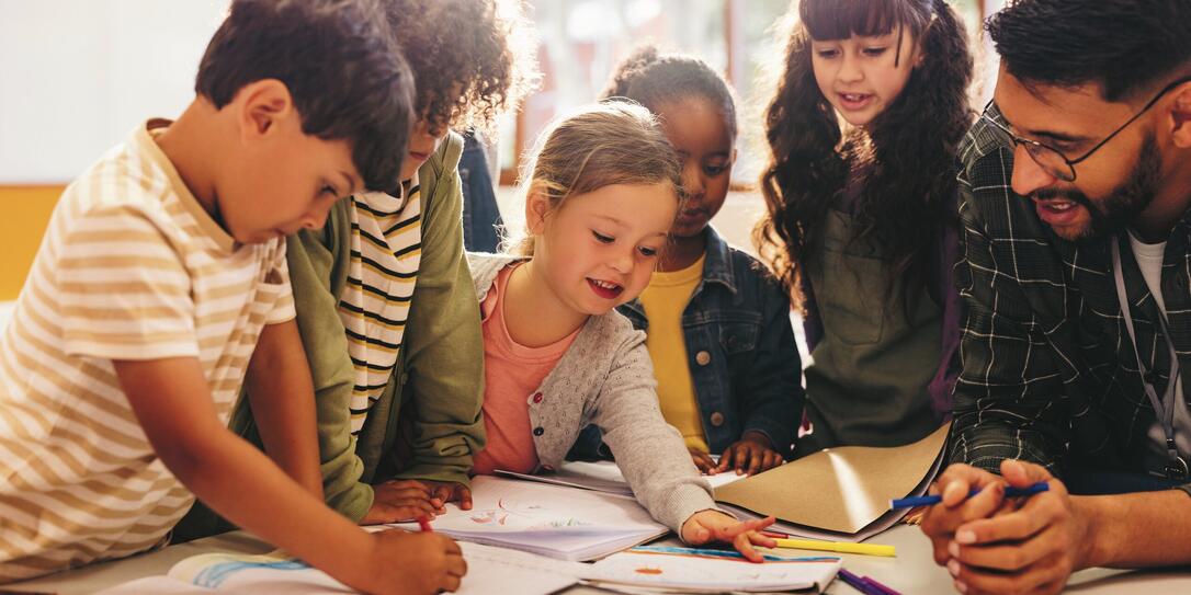 Group of children doing an art project with their teacher
