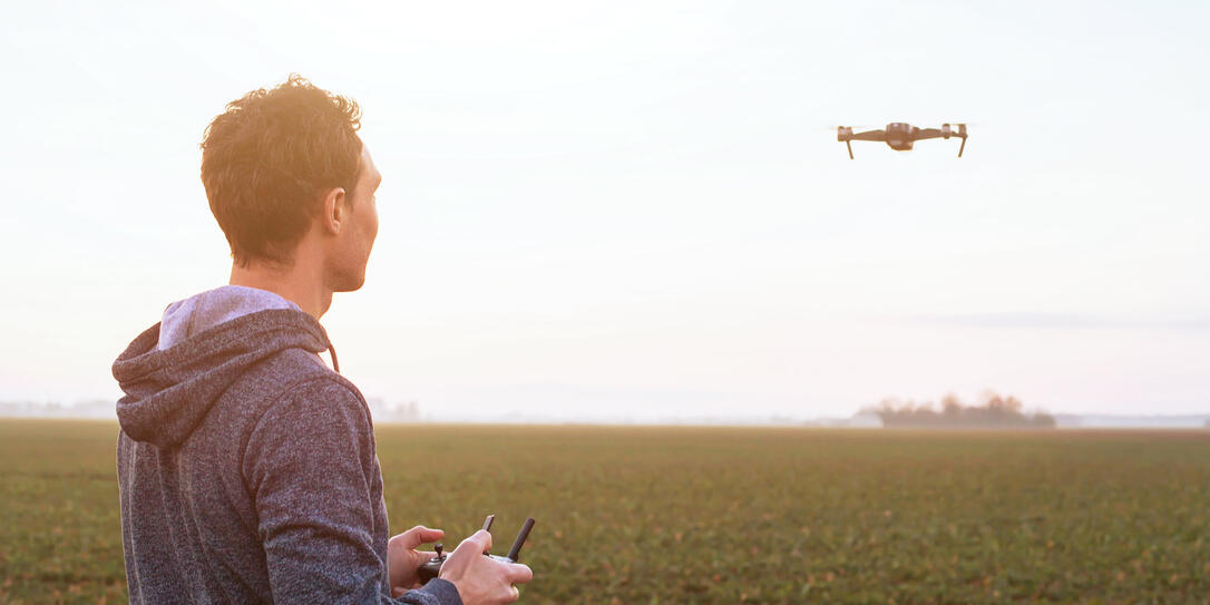 man piloting drone