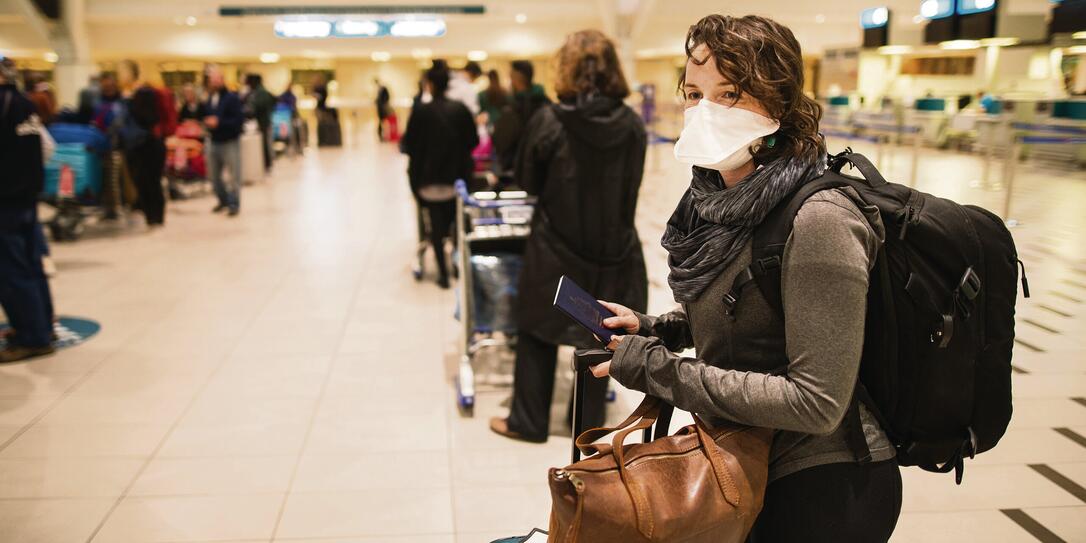 At the airport with a face mask At the airport with a face mask