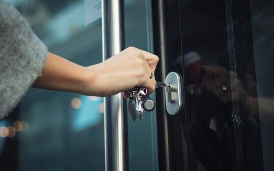 Locking door with a key.