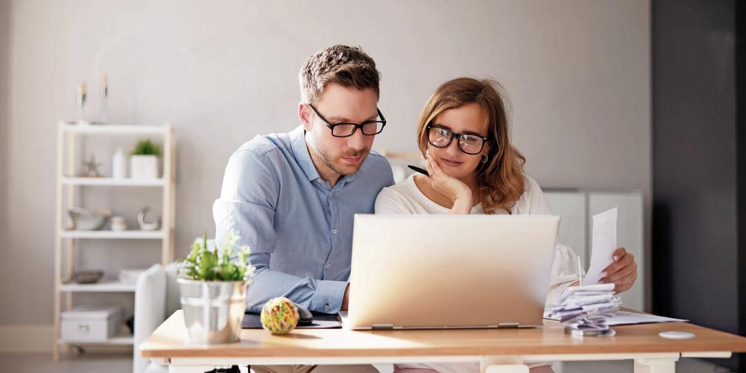 Happy Family Using Calculator For Tax