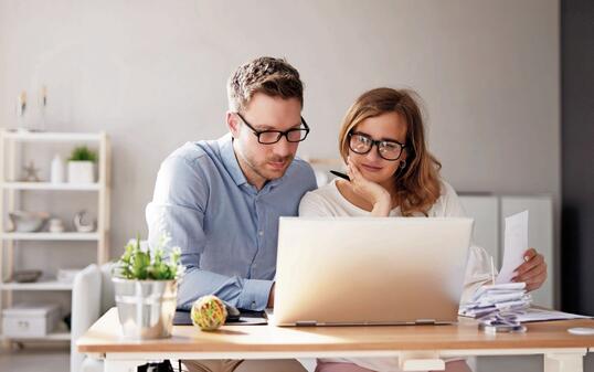 Happy Family Using Calculator For Tax