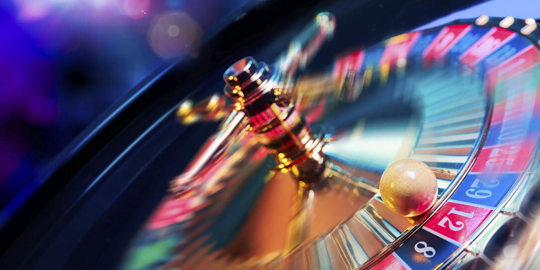 Roulette wheel in motion with a bright and colorful background Roulette wheel in motion with a bright and colorful background