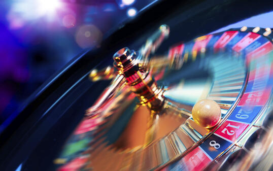 Roulette wheel in motion with a bright and colorful background