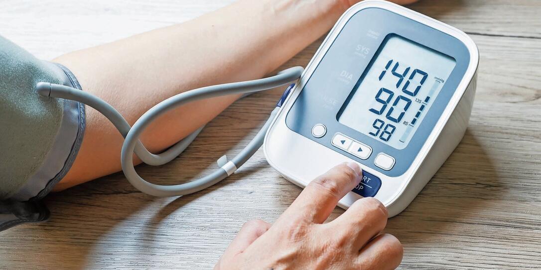 Man checks blood pressure monitor and heart rate monitor with digital pressure gauge. Health care and Medical concept.