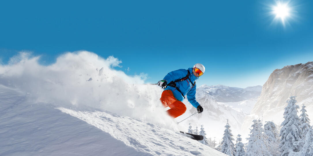 Man skier running downhill