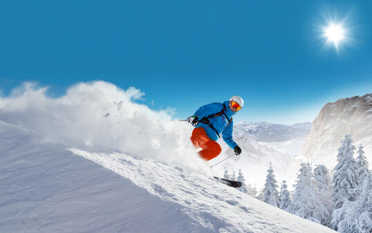 Man skier running downhill