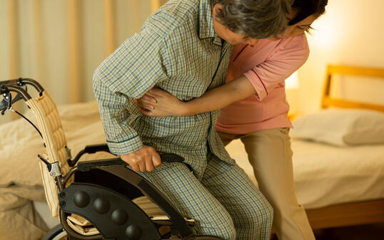 Carer caring for senior man