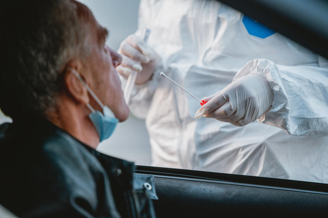 Senior Male Car Passenger at Drive Thru Medical Test Site