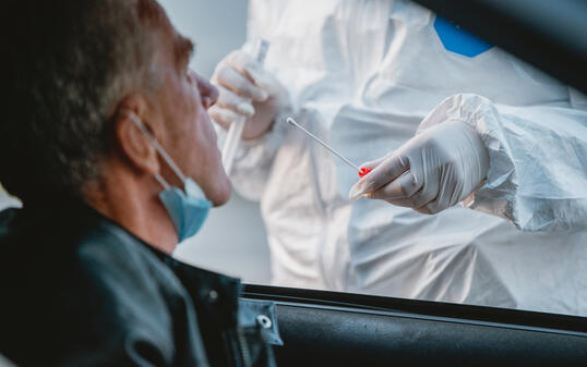 Senior Male Car Passenger at Drive Thru Medical Test Site