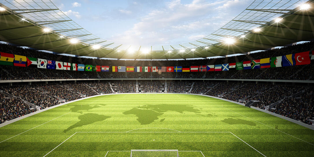 Soccer stadium with international flags and the world map on the field