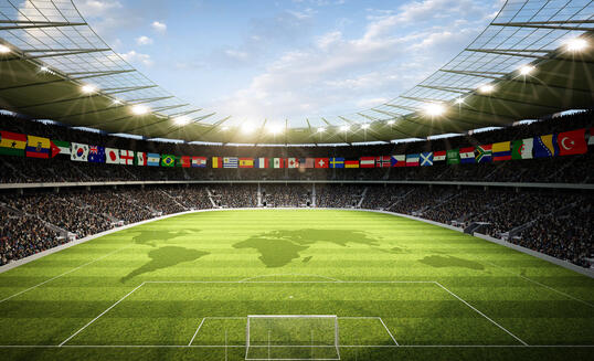 Soccer stadium with international flags and the world map on the field