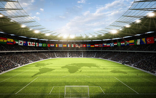 Soccer stadium with international flags and the world map on the field