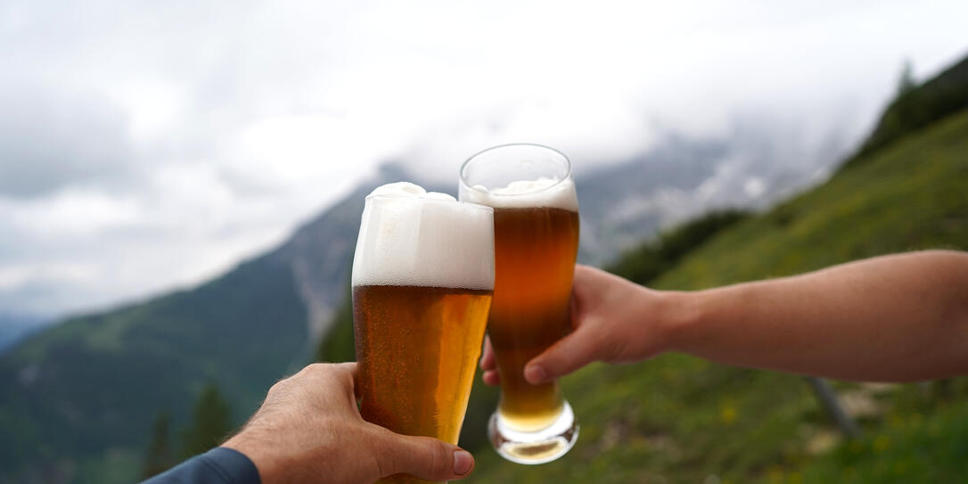 glass of beer in hand on a mountain hut in Werfenweng, Salzburg
