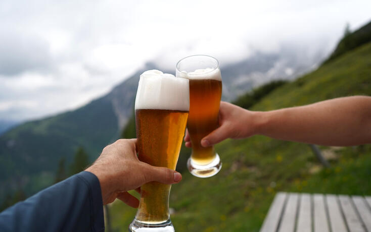glass of beer in hand on a mountain hut in Werfenweng, Salzburg