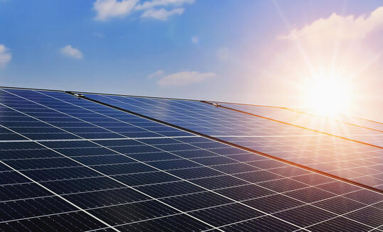 Solar panels with sunset and blue sky background. Clean power energy concept