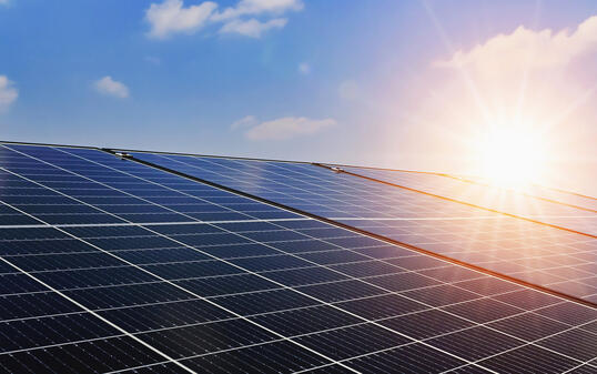 Solar panels with sunset and blue sky background. Clean power energy concept