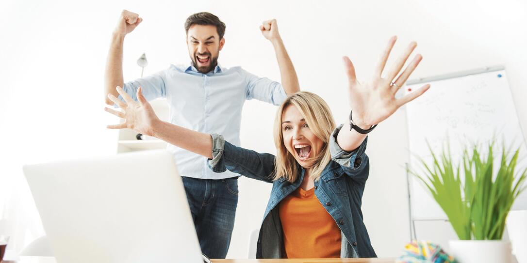 Cheerful young office workers are expressing happiness
